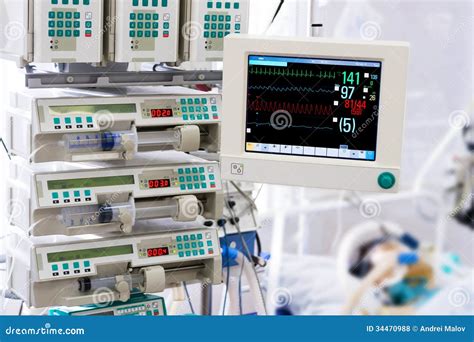 Patient With Monitor And Infusion Pumps In An Icu Stock Photo Image