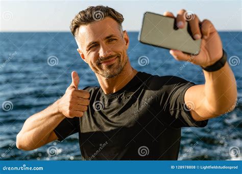 Happy Adult Man Taking Selfie With Smartphone And Showing Thumb Up