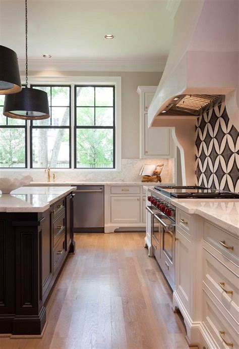 Flooring boards can have a slight greyish cast and a pinkish tint. White kitchen with dark island, cement tile backsplash and ...