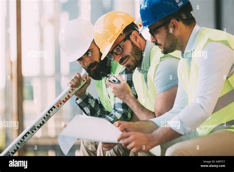 Portrait Of Construction Engineers Working On Building Site Stock Photo