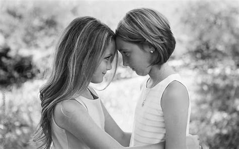 Two Young Girls Facing Each Other Looking Eye To Eye Connecting By Dina