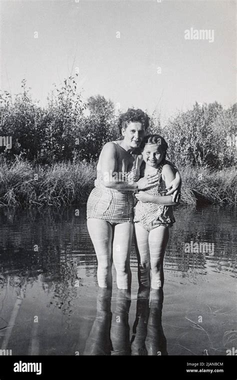 Vintage Photo Of A Mother And Daughter Wearing Bathing Suits Standing In A Reflective Pond
