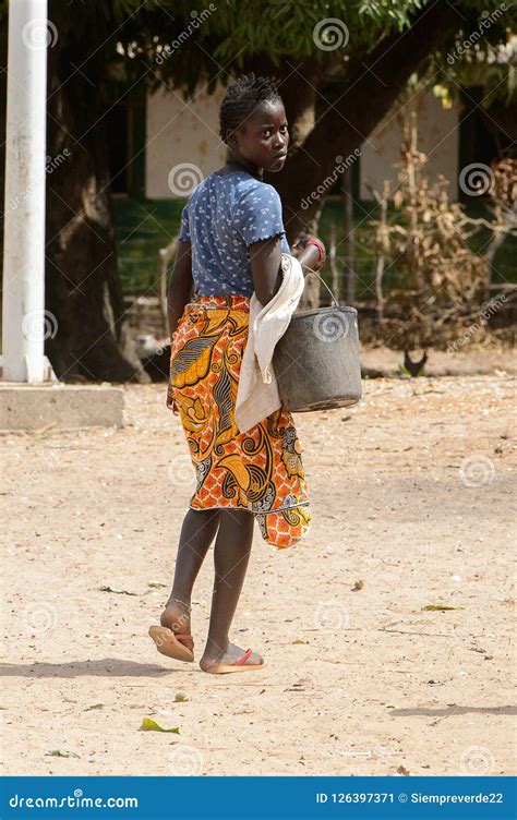 unidentified local woman carries a bucket in the etigoca villag editorial photo image of
