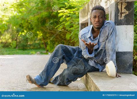 Young Homeless African Man Begging For Food On The Bridge Stock Image