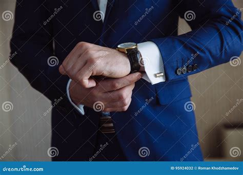 Businessman Checking Time On His Wristwatch Men`s Hand With A Watch
