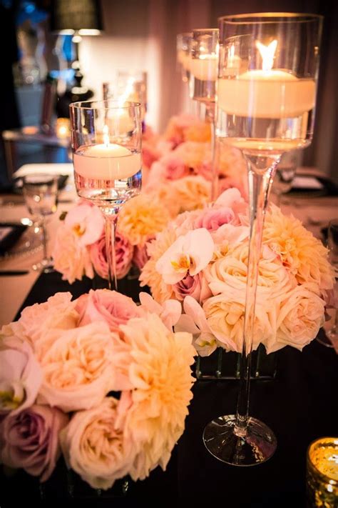 The Centerpieces Are Filled With Flowers And Candles