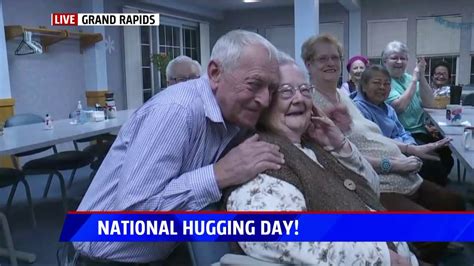 Mike Davis And Nicole Didonato Pass Out Hugs For National Hugging Day