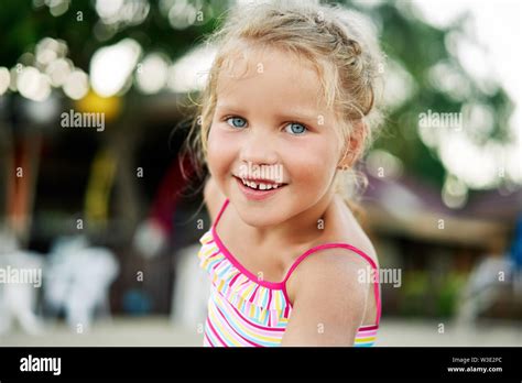 Close Up Portrait Of Happy Cute Little Blonde Girl Smiling Blonde
