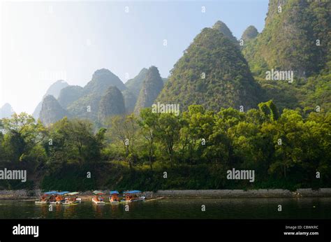 Tour Boat Rafts On The Li River Guangxi China With Karst Dome Mountains
