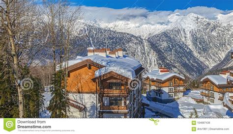 Snow Covered Cottages Against The Backdrop Of The Mountains Mountain