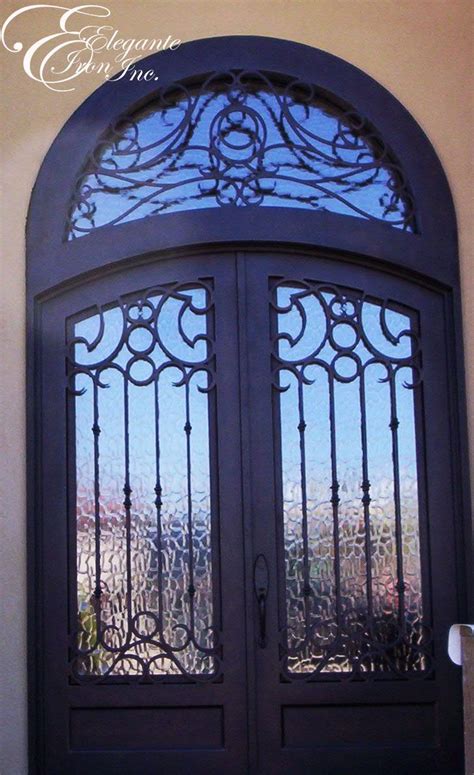 Custom Wrought Iron Door With Eyebrow Arch And An Attached Full Arch