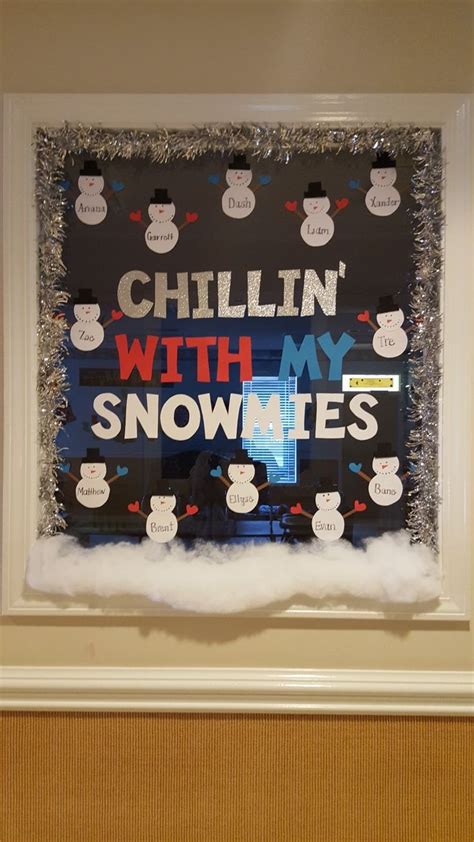 A Bulletin Board With Snowmen On It In The Middle Of A Room That Says