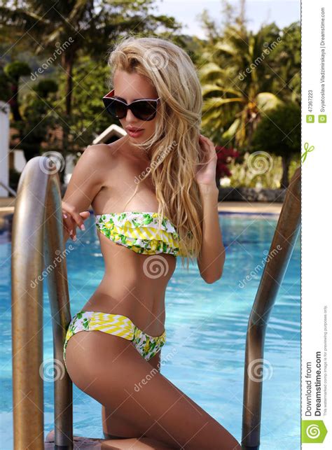 Sexy Woman With Blond Hair In Bikini And Sunglasses Posing