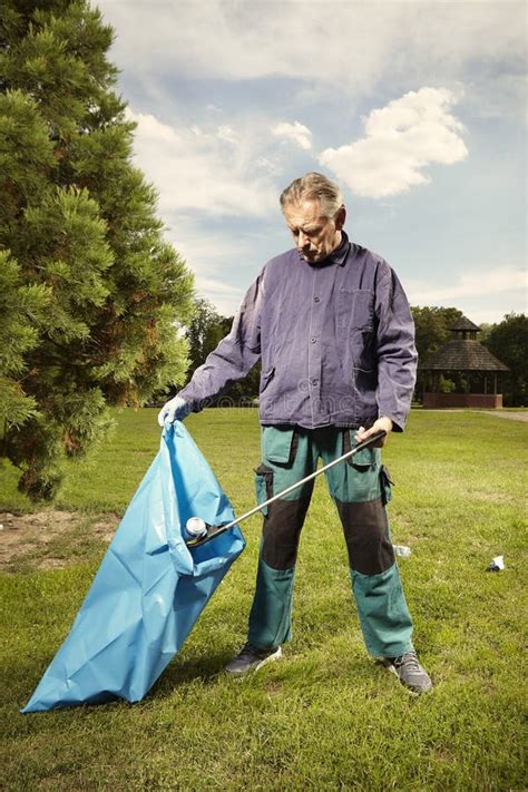 Man At Work Pick Up Garbage On Grass In Park Stock Image Image Of