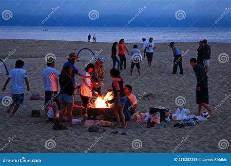 A Group Of Friends Gather Around A Bonfire Editorial Stock Photo