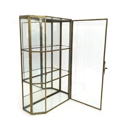 Large brass/glass display case curio mirror backed free standing/wall hanging. Lovely glass curio cabinet or glass display case. This ...