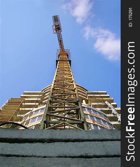 Tall Orange Crane Constructing New Business Building Free Stock