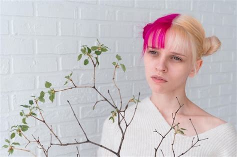 Premium Photo Young Woman With Pink Hair Holding Tree Branch With
