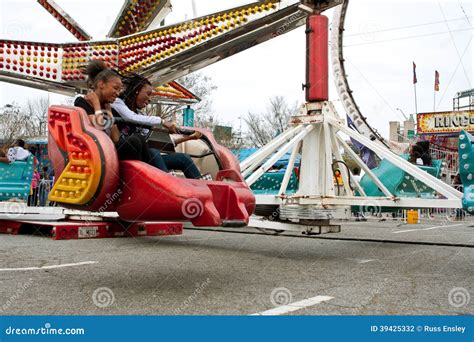 teens enjoy fast moving carnival ride at fair editorial photography