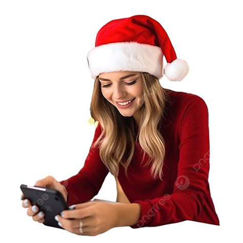 una chica con una gorra navideña roja festiva en una mesa en la cocina mira un teléfono