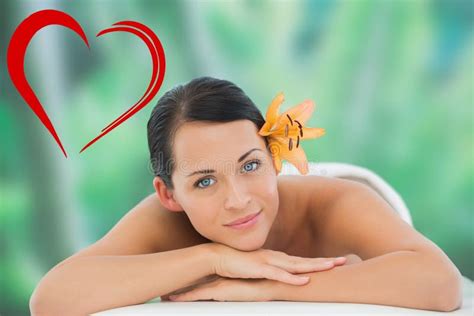 Composite Image Of Beautiful Brunette Relaxing On Massage Table Smiling At Camera Stock Image