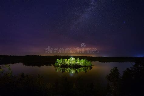 Mysterious Illuminated Island On The Forest Lake At Night Stock Image
