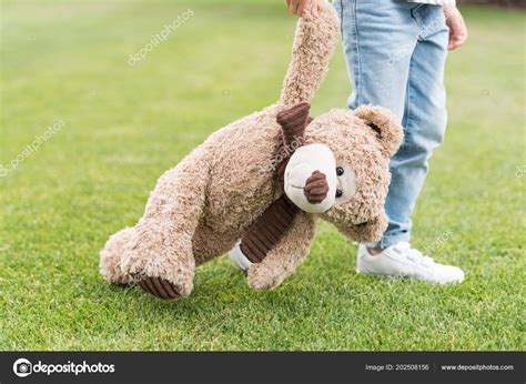 Cropped Shot Child Holding Teddy Bear While Standing Green Lawn Stock