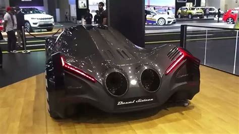 A Futuristic Car Is On Display At An Auto Show