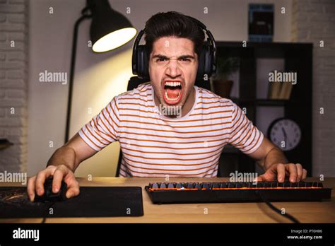 Portrait Of Angry Irritated Gamer Guy Screaming While Playing Video