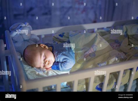 Adorable Newborn Baby Boy Sleeping In Crib At Night Little Boy In