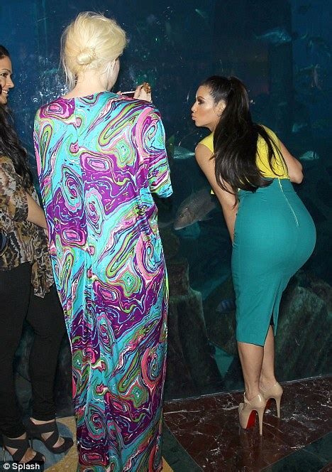 Kim Kardashian Cant Help Showing Off Her Famous Rear As She Poses For