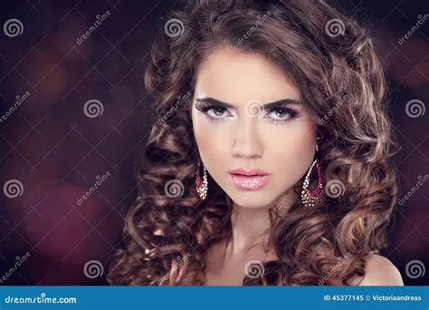 Beautiful Brunette Woman Long Wavy Hair Fashion Earring Professional Makeup Stock Image