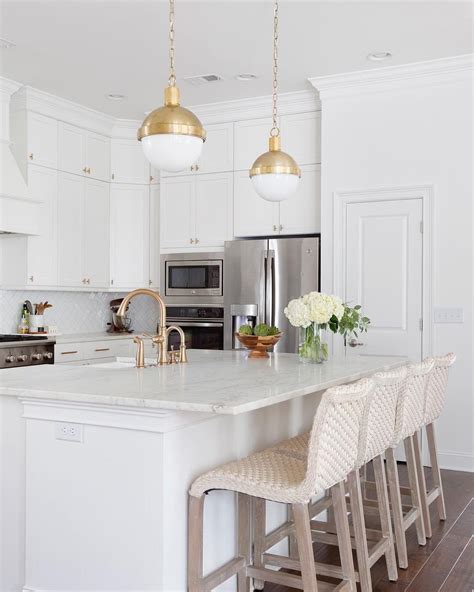 Brass Accents Bring A Warm Glow To This All White Kitchen