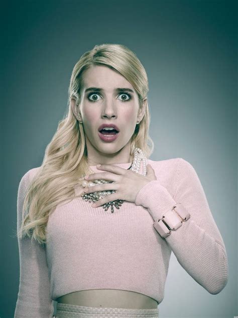 A Woman With Long Blonde Hair Wearing A Pink Sweater And Bracelets
