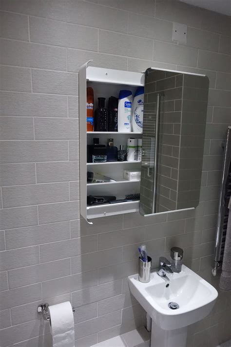 A mirror on the wall helps add depth to a room and makes it more dynamic. The bathroom cabinet was purchased from ikea (Brickan ...