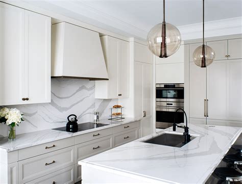 Fresh kitchen with its gorgeous view from backsplash windows. Cambria Quartz Brittanicca Countertops White Cabinets ...