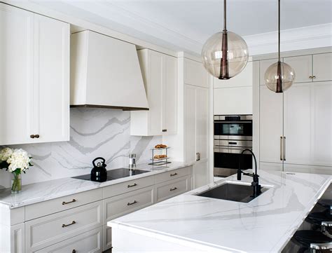 Quartz countertops have won many hearts since their emergence. Cambria Quartz Brittanicca Countertops White Cabinets ...