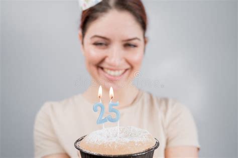 The Happy Woman Makes A Wish And Blows Out The Candles On The 25th