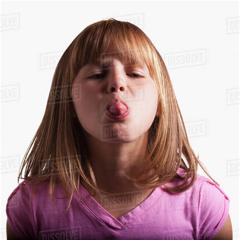 Young Girl Sticking Tongue Out Stock Photo Dissolve