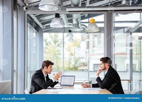 Two Businessmen Working Together On Business Meeting In Office Stock