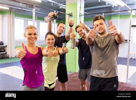 Group Of Happy Friends In Gym Showing Thumbs Up Stock Photo Alamy