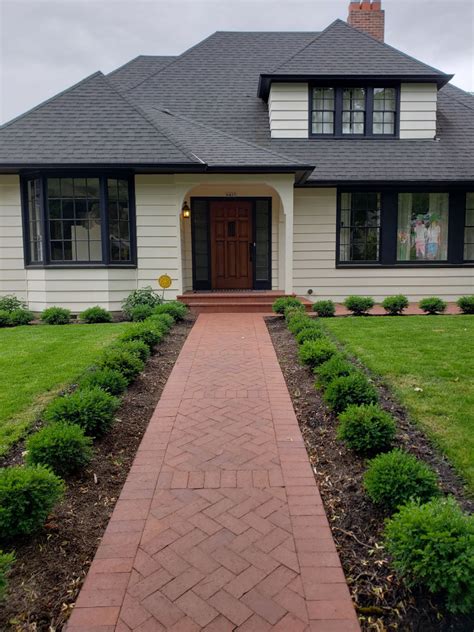 Formal Front Yard With Red Brick Pavers And Boxwood Traditional