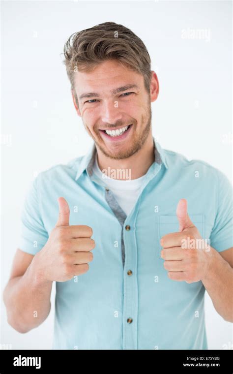 Happy Young Man Gesturing Thumbs Up Stock Photo Alamy
