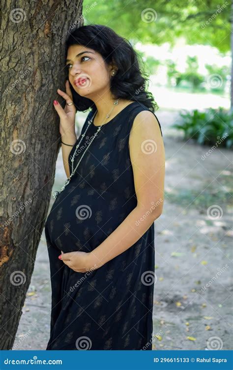 A Pregnant Indian Lady Poses For Outdoor Pregnancy Shoot And Hands On Belly Indian Pregnant