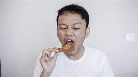 Young Asian Man Is Eating Fried Chicken Wear White Shirt 6516037 Stock