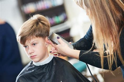 Barber Or Hair Stylist At Work Female Hairdresser Cutting Child Hair