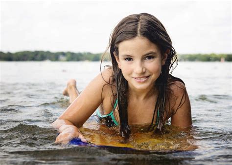 Beautiful Young Girl In Swimsuit On A Kickboard In A Lake Cavf75470