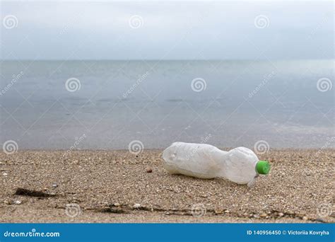 Empty Plastic Bottle On The Sand Garbage On The Beach Sea Shore Stock