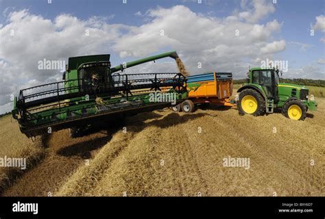 A John Deere combine harvester harvesting barley in a field at Holme