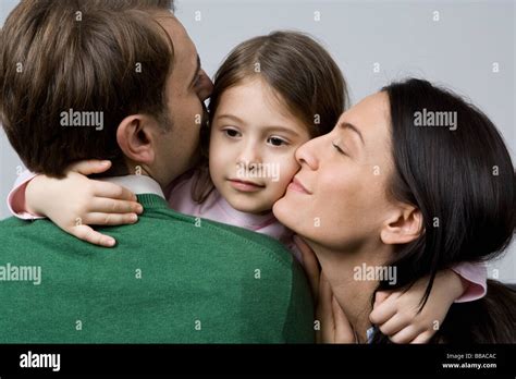 A Daughter Embracing Her Parents Stock Photo Alamy